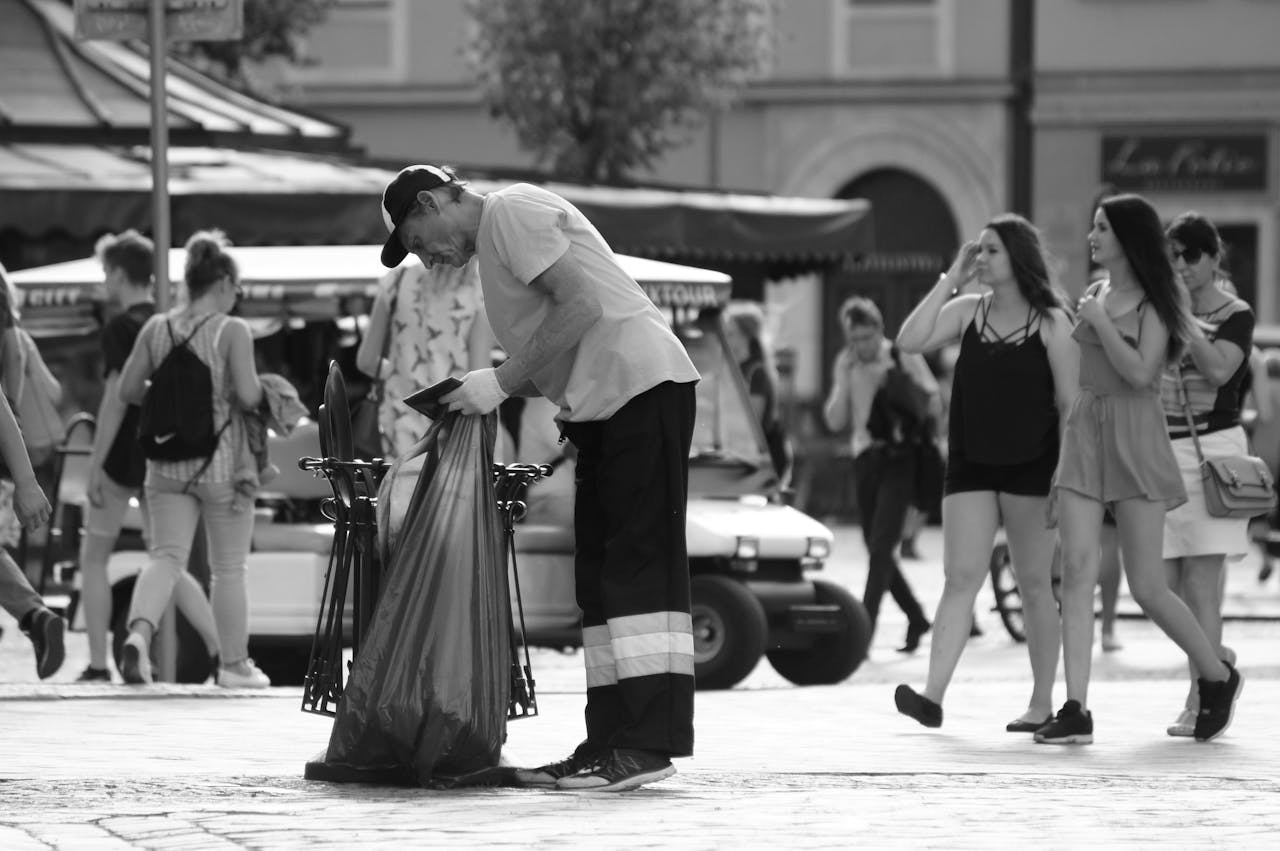 about-us A street cleaner at work in a bustling square in Wrocław, capturing urban life.